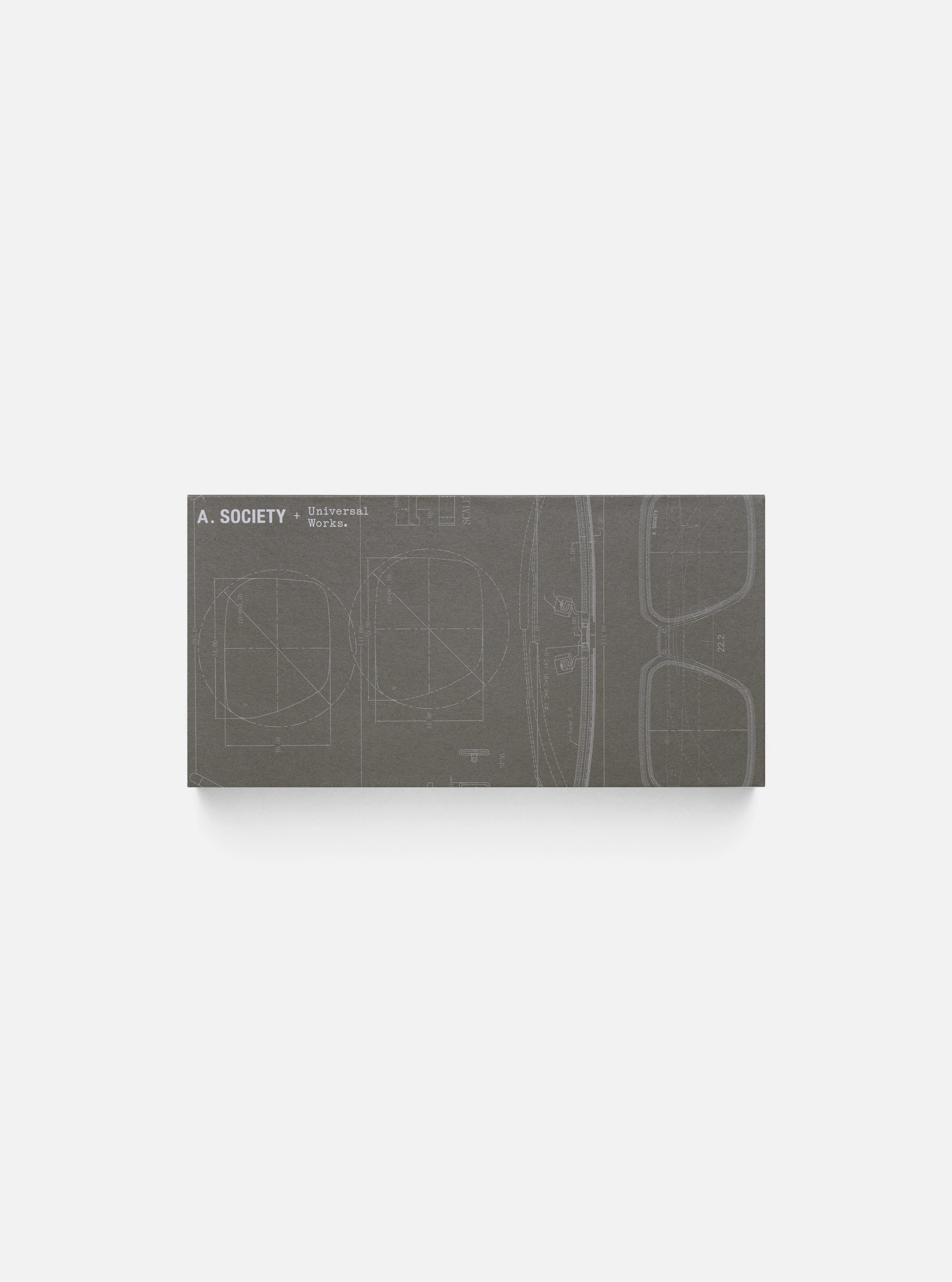 Close-up of the A. SOCIETY x Universal Works Navy Aberdeen Sunglasses case, featuring a blueprint design. Shot on a clean, white background.