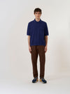 The Navy Fine Texture Tricot S/S Knit Polo is shown as a flat lay against a plain white background. The polo shirt features a classic collar, a three-button placket, and short sleeves. The dark navy fabric has a detailed tricot knit texture, and the collar and sleeve cuffs are finished with fine ribbing.