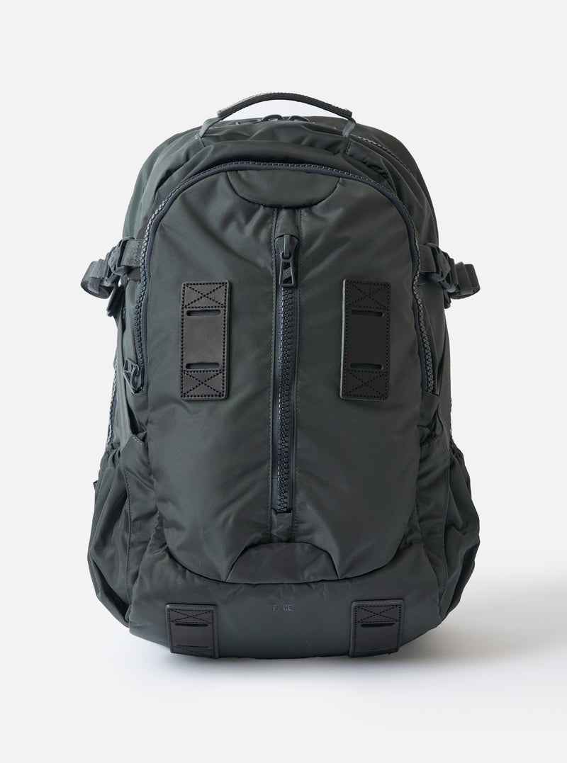 F/CE.® Grey Recycled Nylon 420 re/cor Travel Backpack on a white background. The backpack is a muted grey color and made of a durable nylon material. 