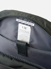 Close-up of the inside of the F/CE.® Grey Recycled Nylon 420 re/cor Travel Backpack. Shows the grey nylon lining, zipper, and care instructions tag. Shot on a white background.
