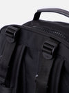The F/CE.® Black Recycled Nylon 420 re/cor Travel Backpack is shown from a rear angle, highlighting the padded back panel made of black neoprene and the ergonomic shoulder straps. The straps feature the Mounting T System with nylon webbing for attachments and an adjustable chest buckle. The backpack is displayed as a flat lay against a plain white background.