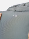 The F/CE.® Foliage Green Recycled Nylon 420 re/cor Travel Backpack is shown from a rear angle against a plain white background. This view highlights the ergonomic shoulder straps equipped with the MOUNTING T SYSTEM and a padded back panel made of technical neoprene. The foliage green recycled nylon fabric has a subtle sheen, and the adjustable straps and top handle are clearly visible.