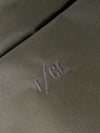 Close-up of the F/CE.® Sage Green 420 re/cor Sacoche. The sage green fabric shows a tight weave. The F/CE logo is embroidered in a matching thread. Studio shot.