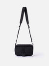 The F/CE. Black Recycled Nylon 420 re/cor Holiday Sacoche is shown as a flat lay against a white background. The small black travel bag features a main zipped compartment, a front zip pocket, and an adjustable shoulder strap with a plastic buckle. A white F/CE. brand label is stitched on the front.