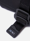 The F/CE.® Black Recycled Nylon 420 re/cor Holiday Sacoche is shown as a flat lay against a plain white background. The compact, rectangular travel bag features two zippered compartments, an adjustable and detachable shoulder strap with plastic buckles, and a small brand label on the front. The black recycled nylon fabric has a smooth, technical appearance.