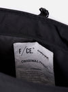 The F/CE. Black Recycled Nylon 420 re/cor Courier Shoulder Bag is shown from a rear angle as a flat lay against a plain white background. The image highlights the padded mesh back panel, the adjustable shoulder strap with a one-touch plastic buckle, and the smooth black recycled nylon fabric.