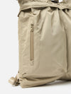 Close-up of the F/CE.® Sage Green Recycled Twill 3-Way Helmet Bag on a white background. Shows the texture of the sage green recycled twill and the zipper detail.