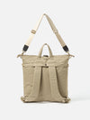 The F/CE.® Sage Green Recycled Twill 3-Way Helmet Bag, shown against a white backdrop. The bag features a sage green twill material with cream straps and black accents.