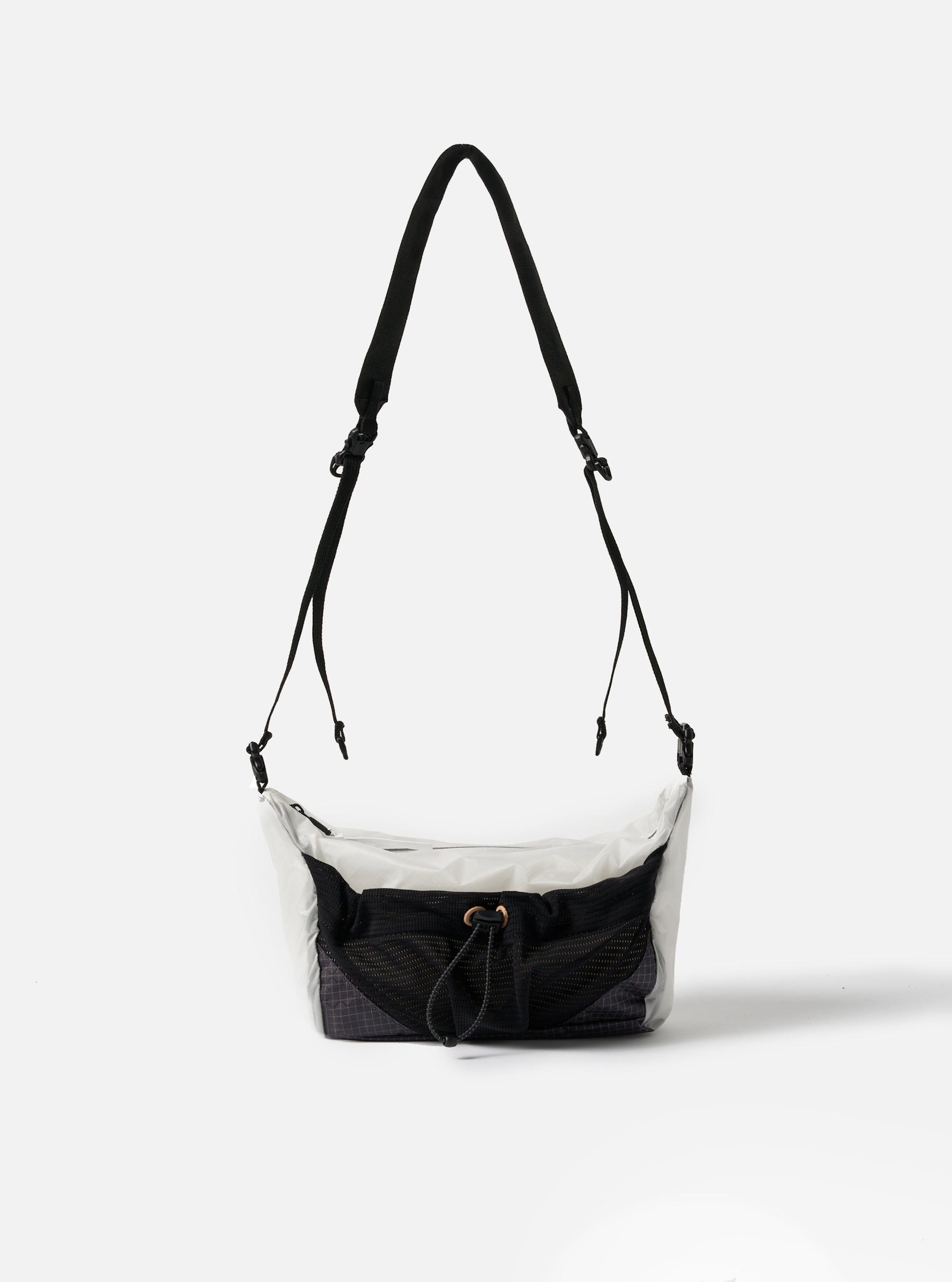 The F/CE.® White Nylon Cordura Sil Sacoche bag hangs against a white backdrop. The bag features a white nylon upper, black mesh pocket, and black straps.