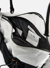 Close-up of the F/CE.® White Nylon Cordura Sil Sacoche, showing its interior. The bag features white nylon and black mesh details. The background is a clean, bright white.