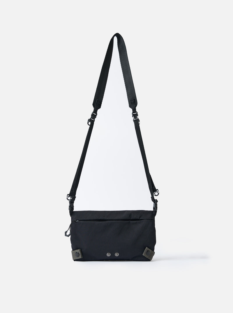 The F/CE.® Black Nylon Textured Twill Drawstring Sacoche bag on a white background. The black bag has a long strap and textured nylon.