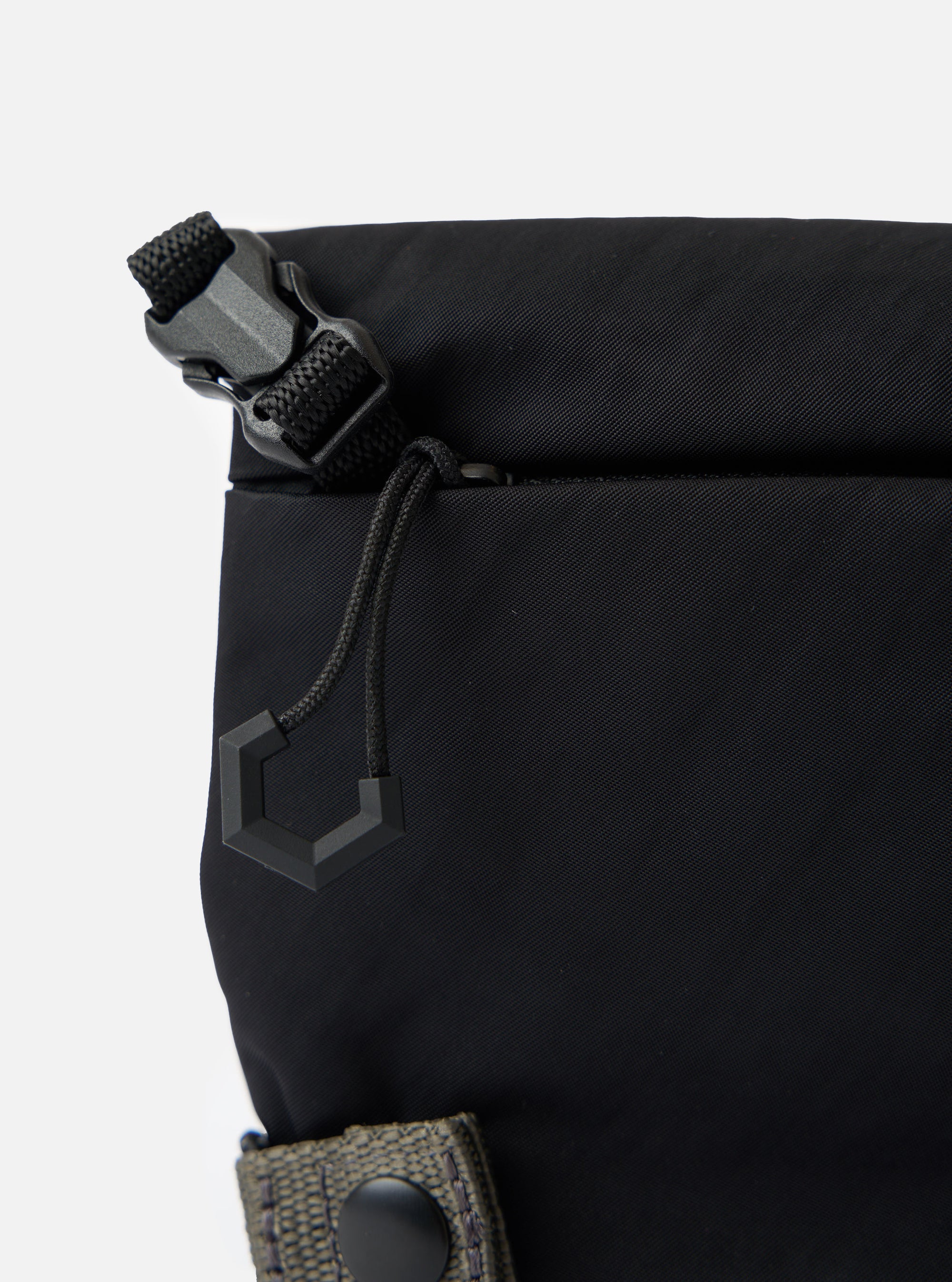 Close-up of the F/CE.® Black Nylon Textured Twill Drawstring Sacoche. Shows the black textured nylon, drawstring detail, and buckle against a white background.