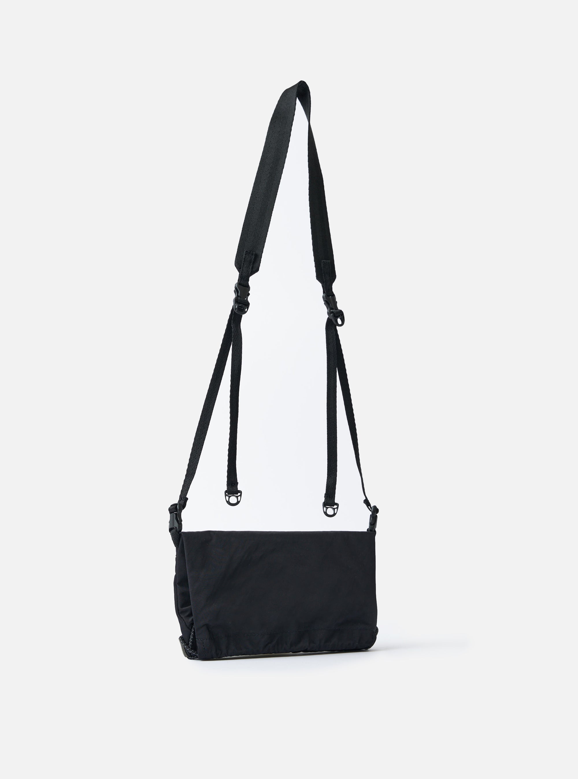 F/CE.® Black Nylon Textured Twill Drawstring Sacoche on a white background. The bag has a black strap and drawstring closure. The material looks durable and textured.