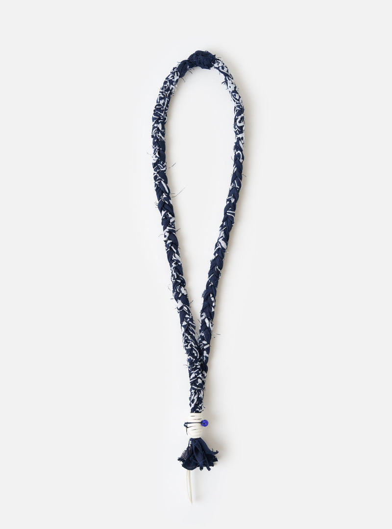 Hanami of Rome Blue/White Leather/Blue Bead Bandana Necklace No.47 on a white surface. The necklace is made of braided blue and white fabric with a blue bead detail.