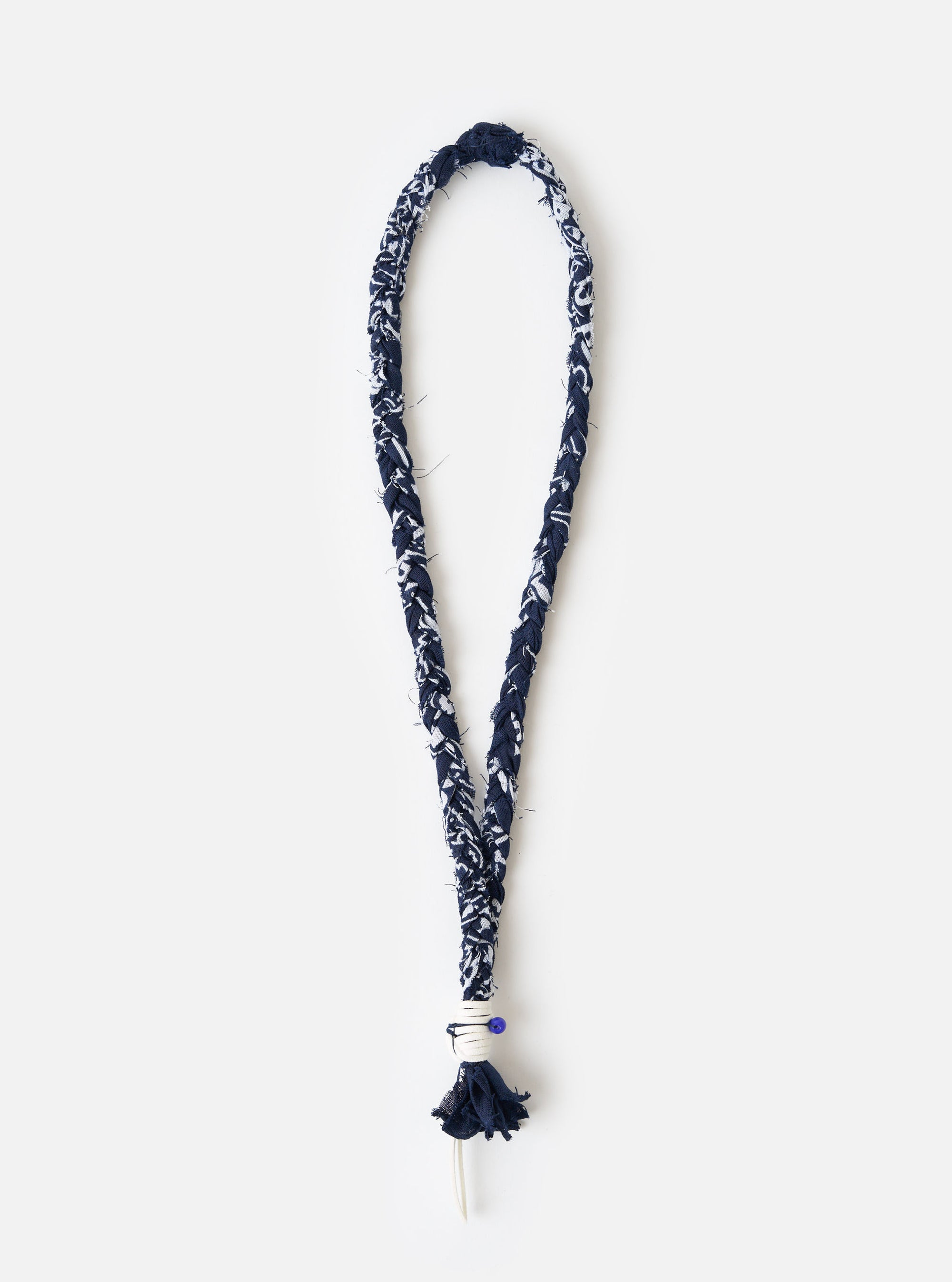 Hanami of Rome Blue/White Leather/Blue Bead Bandana Necklace No.47 on a white surface. The necklace is made of braided blue and white fabric with a blue bead detail.