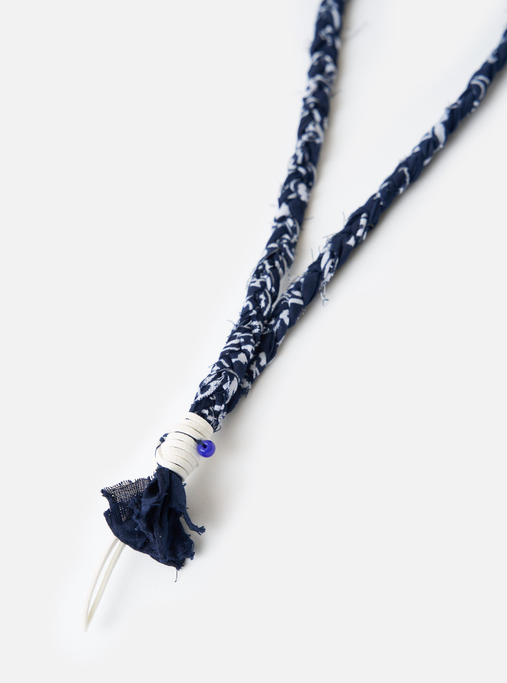 Hanami of Rome Blue/White Leather/Blue Bead Bandana Necklace No.47 on a white surface. The necklace features a blue and white bandana-patterned fabric, leather accents, and a blue bead.