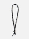 Hanami of Rome Black/Black Leather/White Turquoise Bead Bandana Necklace No.48 on a white background. The necklace is made of black and white patterned fabric and has a leather tassel.