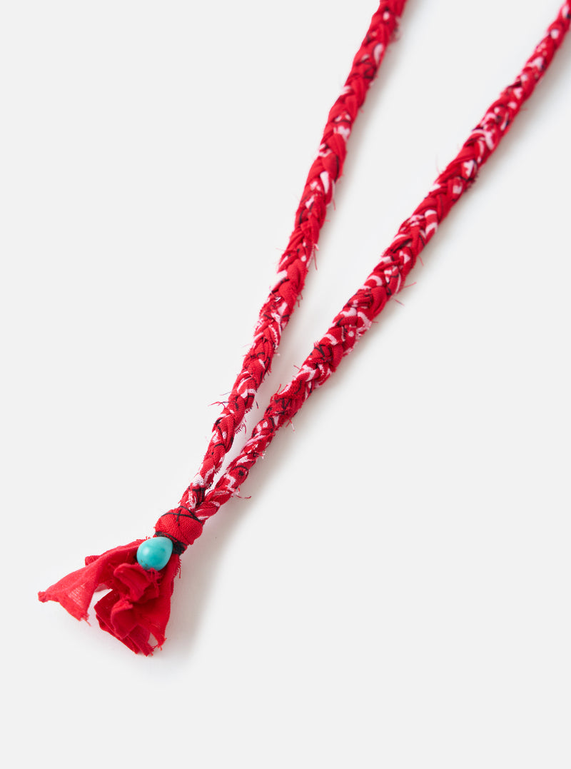 Close-up of the Hanami of Rome Red/Turquoise Bead Bandana Necklace No.49 on a white background. The necklace features a red and white braided band with a turquoise bead.