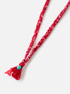 Close-up of the Hanami of Rome Red/Turquoise Bead Bandana Necklace No.49 on a white background. The necklace features a red and white braided band with a turquoise bead.