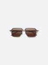 A. SOCIETY x Universal Works Kowloon Eyewear in brown and honey tones. Square frames with honey-colored lenses. Shot on a clean, white background.