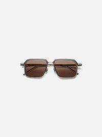 A. SOCIETY x Universal Works Kowloon Eyewear in brown and honey tones. Square frames with honey-colored lenses. Shot on a clean, white background.