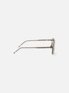 Side view of A. SOCIETY x Universal Works Kowloon Eyewear in brown and honey tones on a white surface. The glasses have a modern, sleek design.