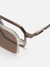 Close-up of A. SOCIETY x Universal Works Brown/Honey Kowloon Eyewear on a white surface. Features brown frames and honey-tinted lenses. Stylish and modern design.
