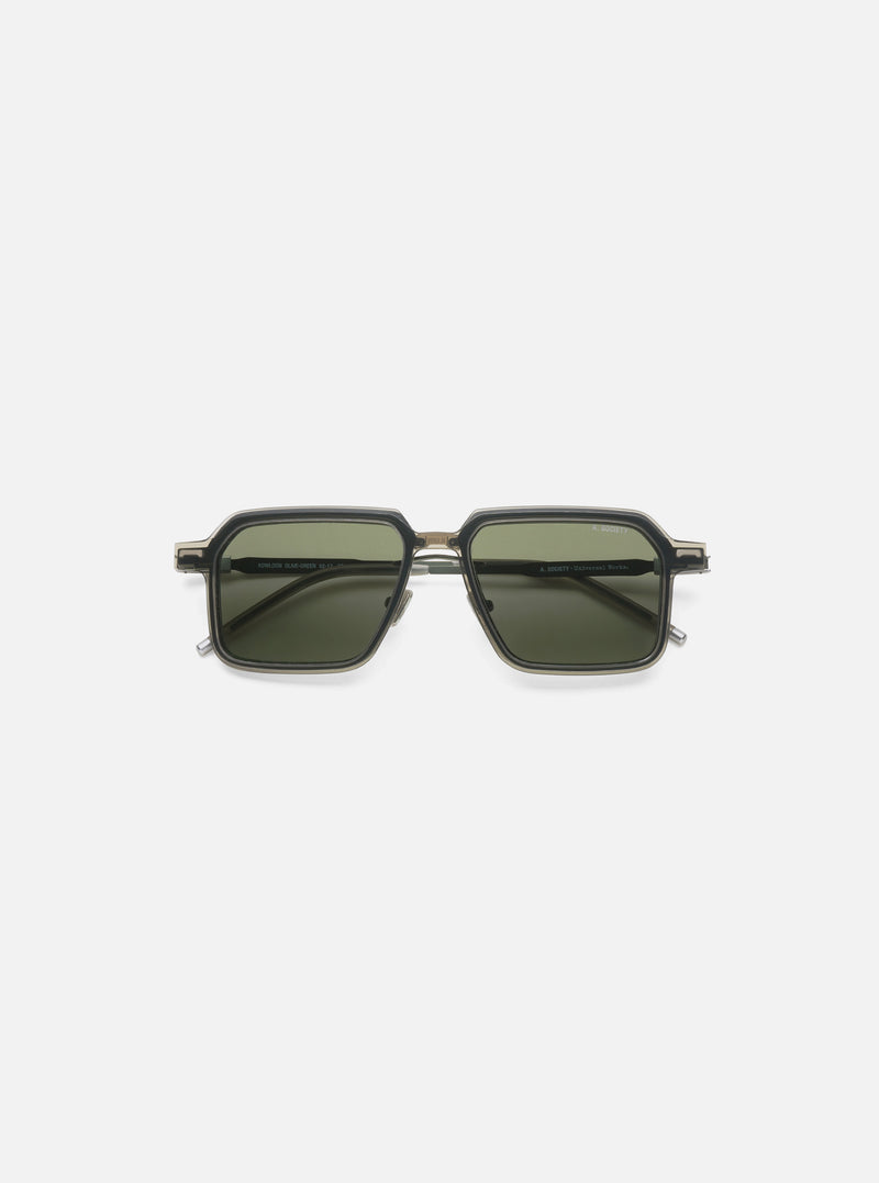 Close-up of A. SOCIETY x Universal Works Olive/Green Kowloon Eyewear on a white background. The frames are olive and green with dark green lenses.