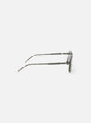 Side view of A. SOCIETY x Universal Works Olive/Green Kowloon Eyewear on a white surface. The frames are olive green with silver accents. 