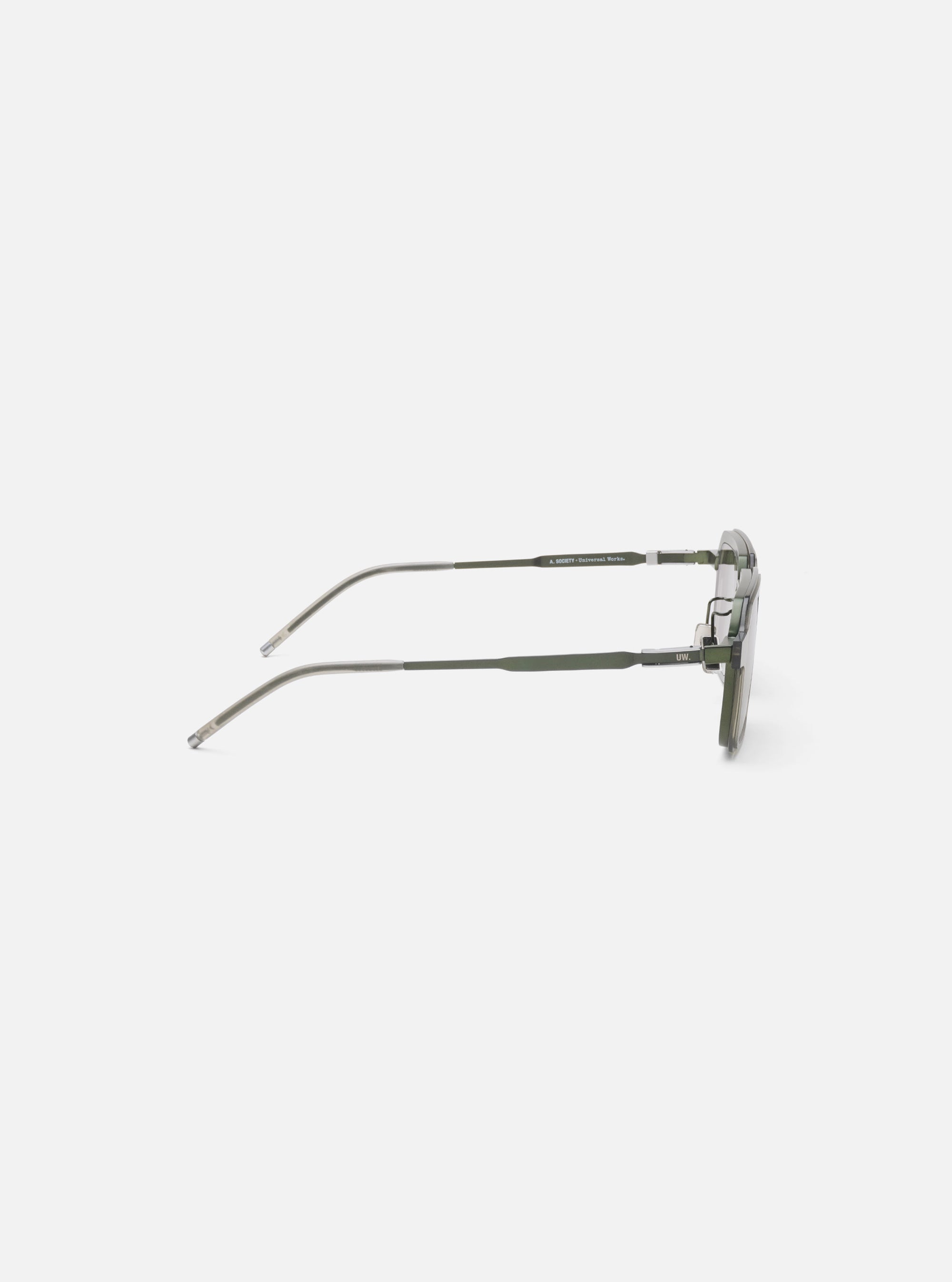 Side view of A. SOCIETY x Universal Works Olive/Green Kowloon Eyewear on a white surface. The frames are olive green with silver accents. 