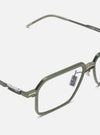 Close-up of A. SOCIETY x Universal Works Olive/Green Kowloon Eyewear on a white background. The glasses have a green metal frame and clear lenses.