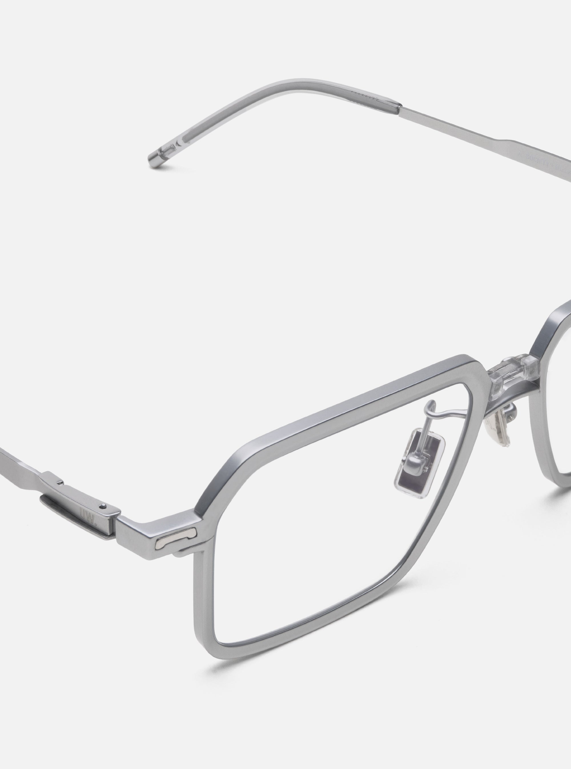 Close-up of A. SOCIETY x Universal Works Silver/Grey Kowloon Eyewear on a white background. The glasses have a square frame and silver-grey metal finish.