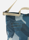 Close-up of the master-piece x Universal Works Blue Camo Recycled Tech Canvas Large Tote Bag. Features blue camo print, beige straps, and text on a white background.