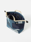 The master-piece x Universal Works Blue Camo Recycled Tech Canvas Large Tote Bag on a white background. The bag features a blue camo pattern and beige straps.