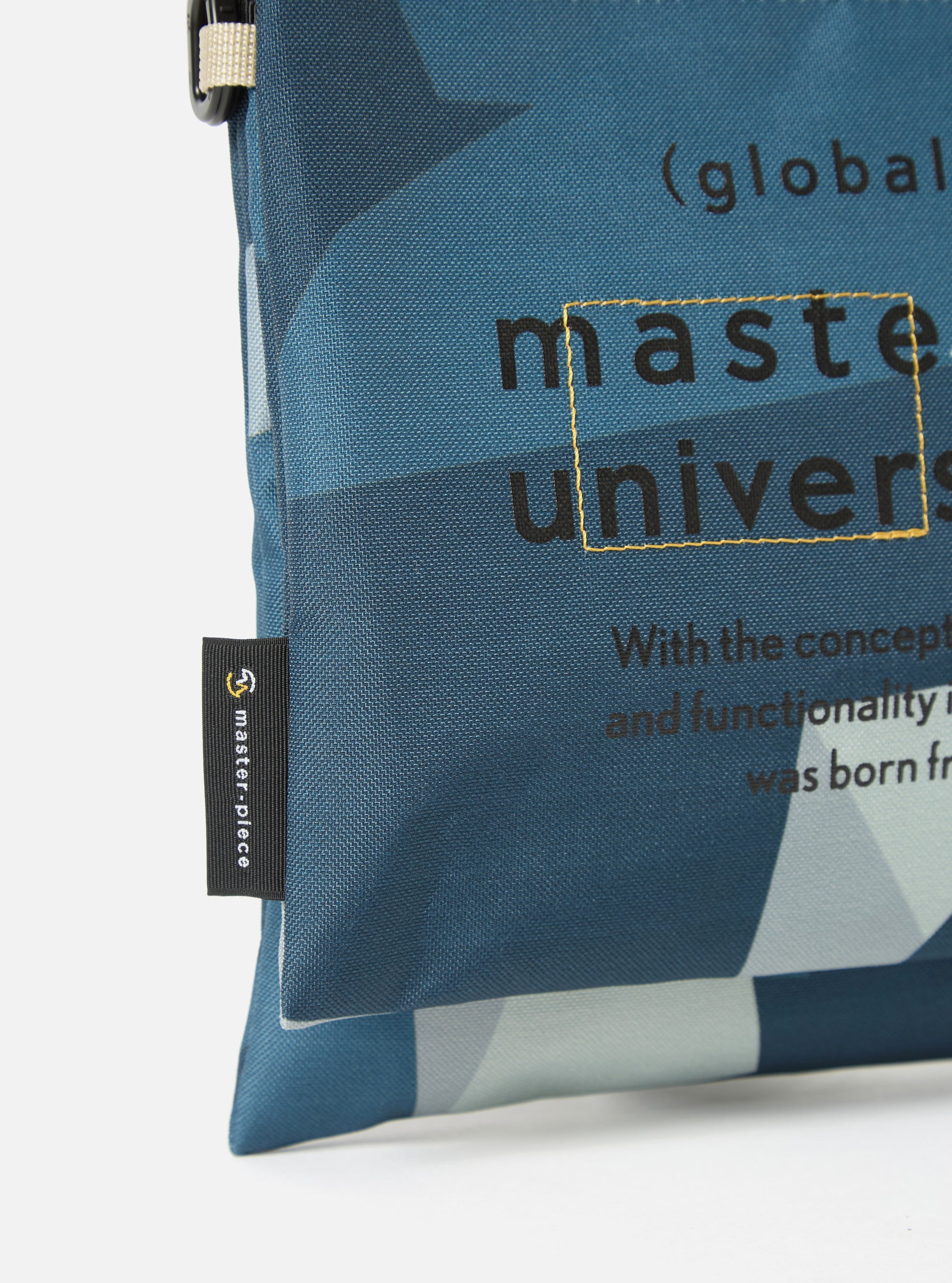 Close-up of the master-piece x Universal Works Blue Camo Recycled Tech Canvas Sacoche against a white background. The blue camo pattern is visible, along with the brand logos.