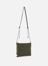 Olive master-piece x Universal Works Sacoche bag in recycled tech canvas. The crossbody bag features a slim profile and adjustable strap, presented on a clean white background.