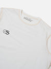 The master-piece x Universal Works White Single Jersey Print Tee is shown from the back as a flat lay against a plain white background. The shirt features a large, central graphic print on the reverse side. The garment has short sleeves and a ribbed crew neck.