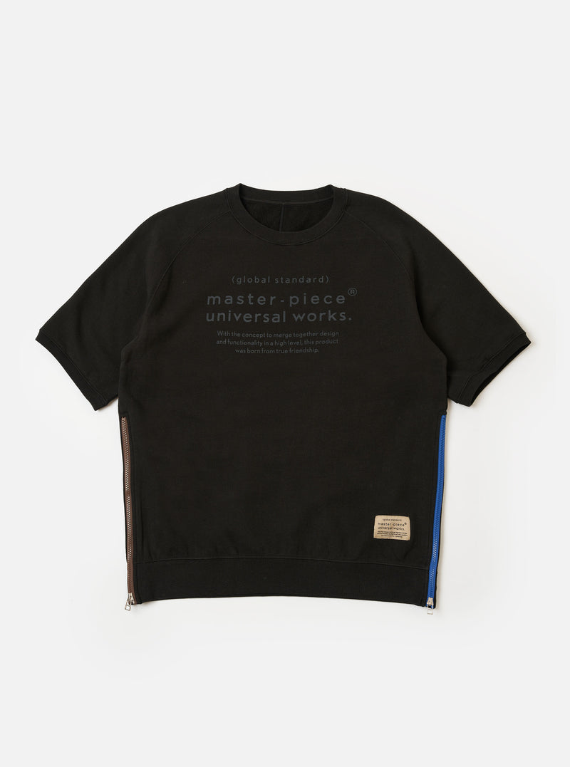 The master-piece x Universal Works Black Brush Back Sweat S/S Billy Sweat is shown as a flat lay against a white background. This short-sleeved sweatshirt features a crewneck, a printed dual-branded logo on the left chest, and contrasting white zips on the side seams.