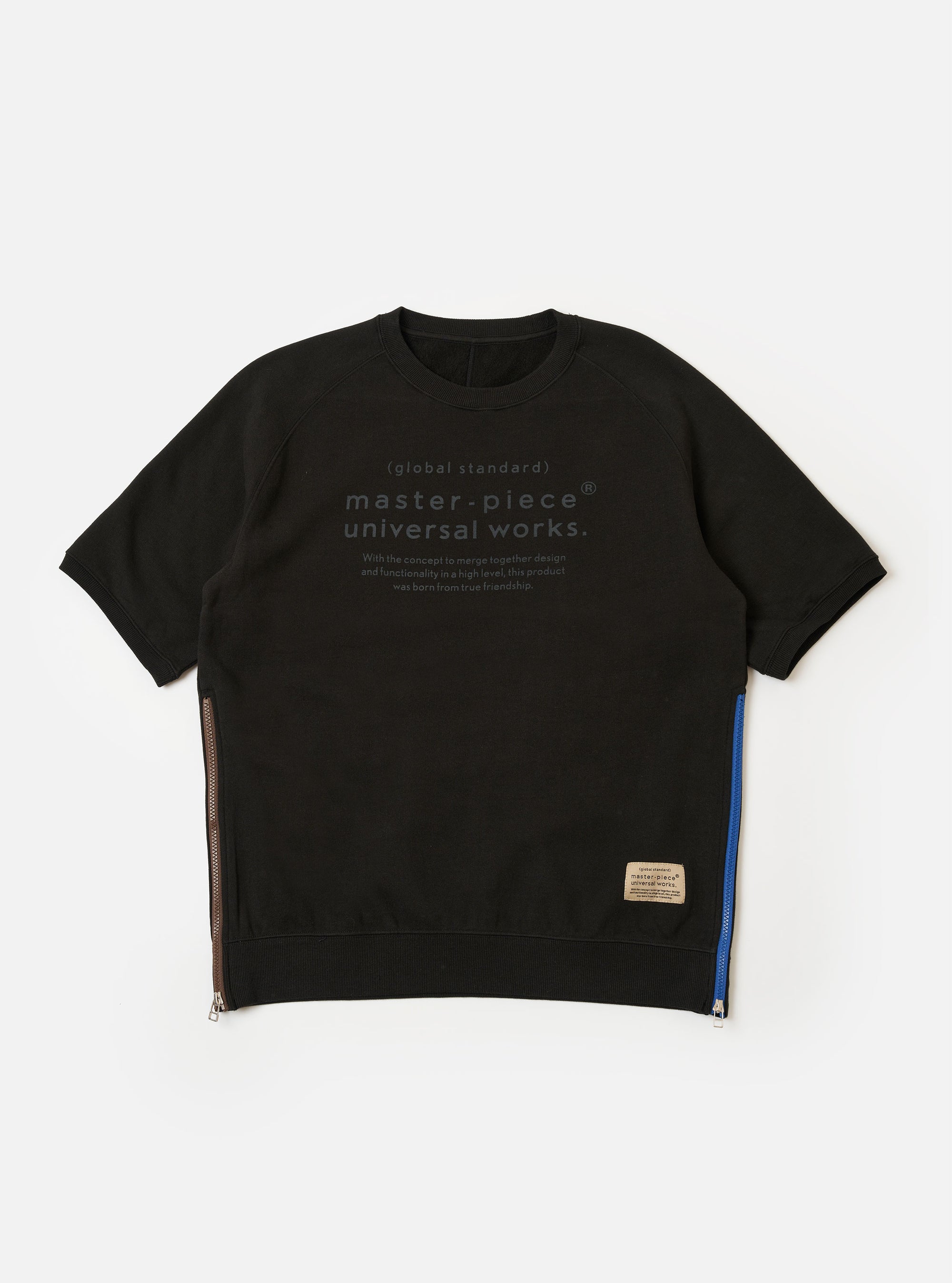 The master-piece x Universal Works Black Brush Back Sweat S/S Billy Sweat is shown as a flat lay against a white background. This short-sleeved sweatshirt features a crewneck, a printed dual-branded logo on the left chest, and contrasting white zips on the side seams.