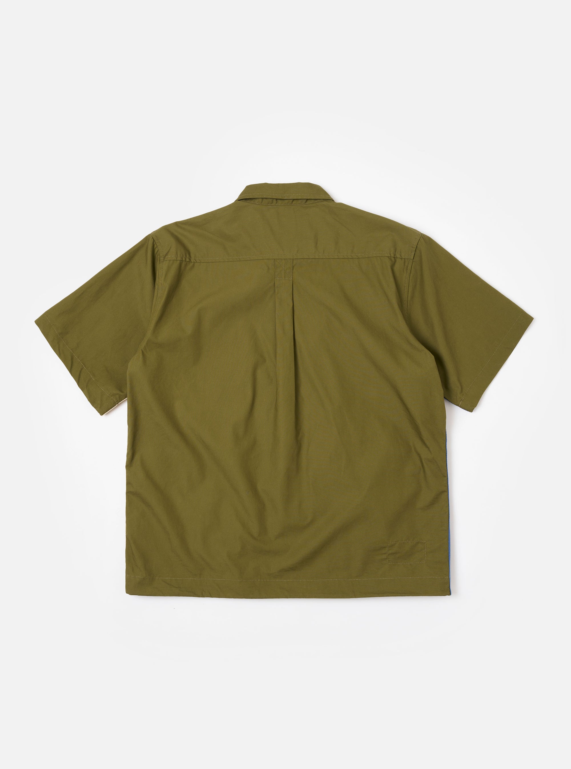 The master-piece x Universal Works Olive Recycled Poly Tech Tech Overshirt is shown from the back as a flat lay against a plain white background. The image highlights the garment's clean construction, featuring a back yoke with a central box pleat and a straight hem. The olive green recycled polytech fabric has a smooth, technical appearance.