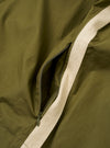 The master-piece x Universal Works Olive Recycled Poly Tech Tech Overshirt is shown in a detail view as a flat lay against a white background. The image focuses on the rear of the garment, highlighting the back yoke with a box pleat and the smooth, technical texture of the olive green recycled polytech fabric.