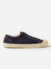 Side view of the Novesta for Universal Works Navy Canvas Star Master shoe on a white background. The shoe is navy canvas with a cream rubber sole.