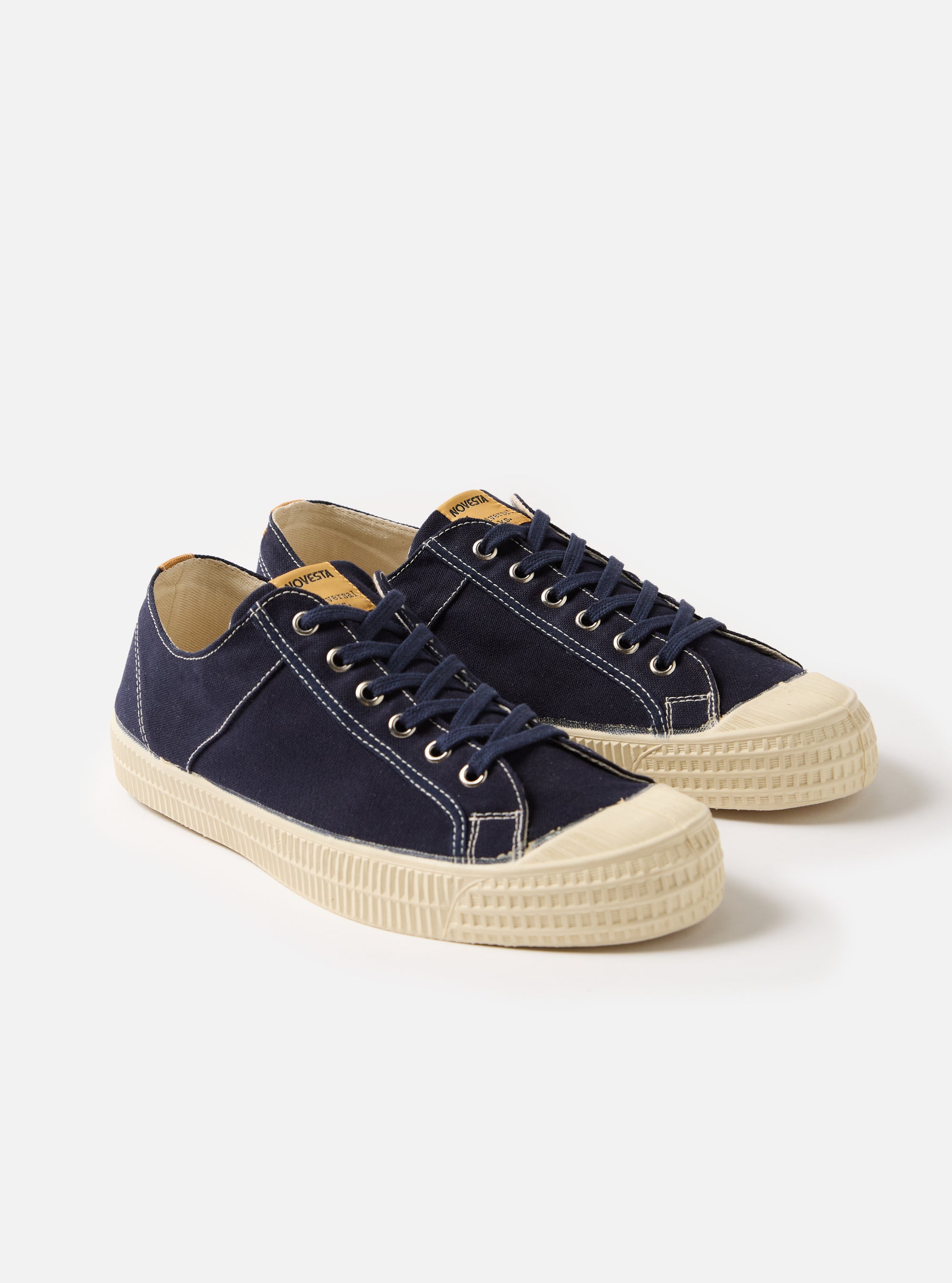 Novesta for Universal Works Navy Canvas Star Master shoes on a white background. The canvas shoes have navy laces and a cream sole.
