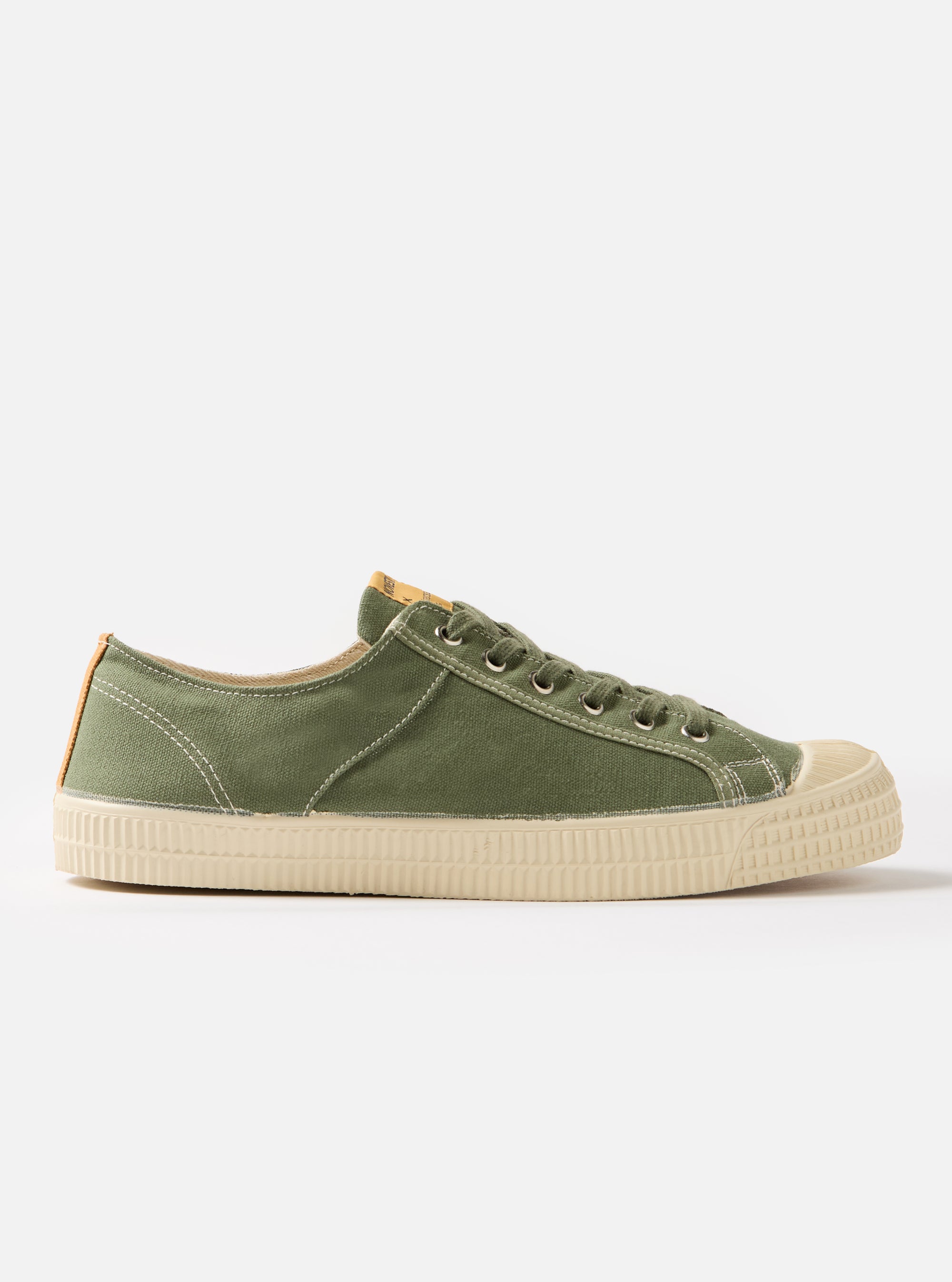 Side view of a Novesta for Universal Works Olive Canvas Star Master shoe on a white background. The shoe is olive green with a cream sole and laces.