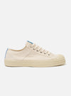 The Novesta for Universal Works Ecru/Pale Blue Canvas Star Master is shown from a side profile against a white background. The sneaker features an ecru canvas upper with military-inspired pale blue contrast stitching and a signature gold canvas heel tape. The shoe has a prominent chunky ecru vulcanized rubber sole with a textured shell toe and silver metal eyelets for the laces.