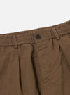 Close-up of Khaki Linen Slub Weave Oxford Pant on a white background. Shows the elasticated waist, button and pocket detail. The linen has a textured slub weave.