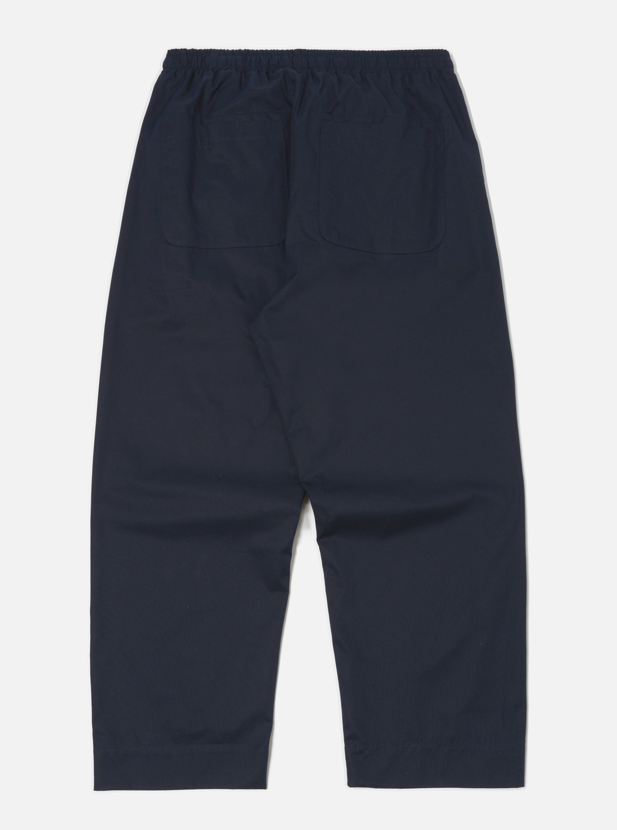 Back view of the Navy Military Cotton Judo Pant on a white background. The pants are a relaxed fit with an elastic waistband and two back pockets.