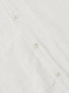 Close-up of the Ecru Deffe Self Stripe Minari Shirt, showing the ecru color, self-stripe texture, and button details. Shot on a flat surface.