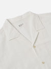 Close-up of the Ecru Deffe Self Stripe Minari Shirt on a white background. The shirt is ecru-colored with a self-stripe pattern. Features a camp collar and button closure.