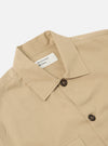 Close-up of the Sand Military Cotton Dockside Overshirt on a white background. The cotton overshirt has a classic collar and dark brown buttons.